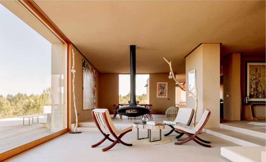 Living room with a hanging fireplace and folding chairs, and a large window