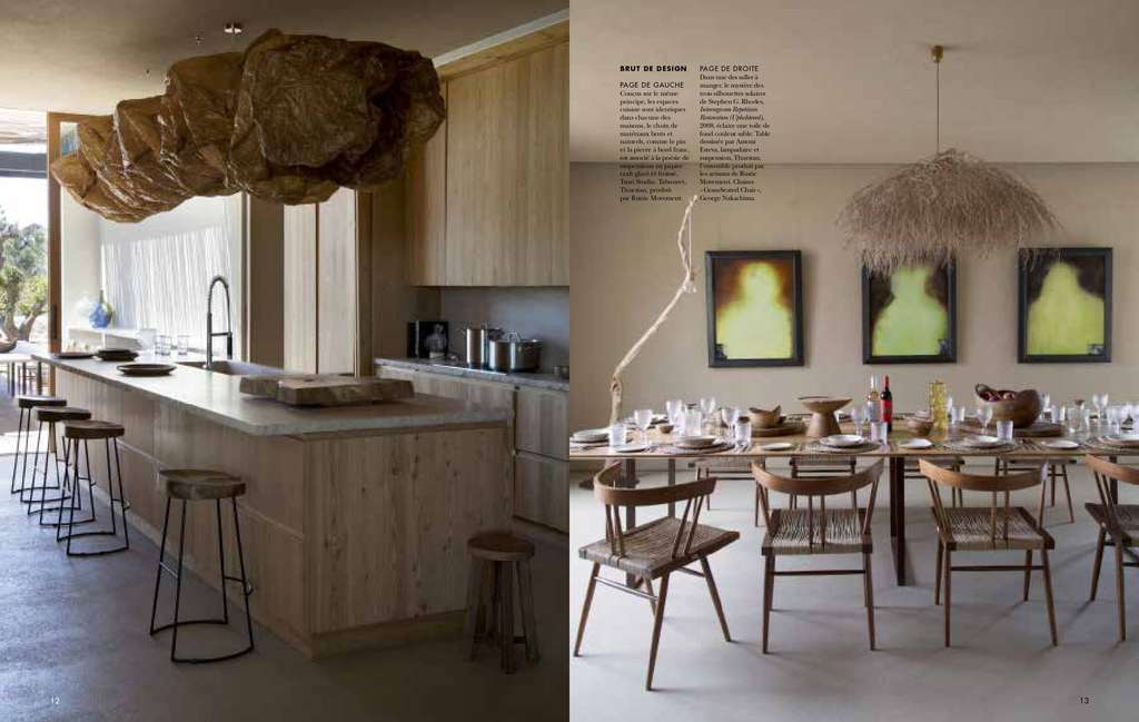 Cote Sud magazine spread of a kitchen with a hanging sculpture and a dining table