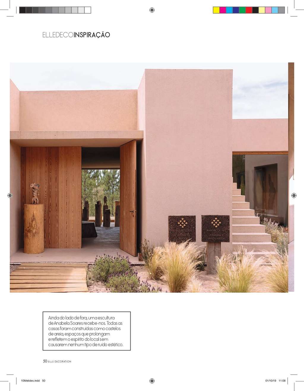 Elle Decoration page with a pink building with wooden entrance doors